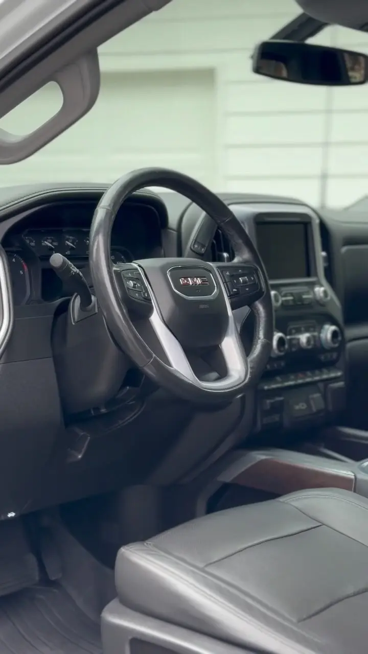 Interior view of a GMC with a clean, detailed dashboard and steering wheel.