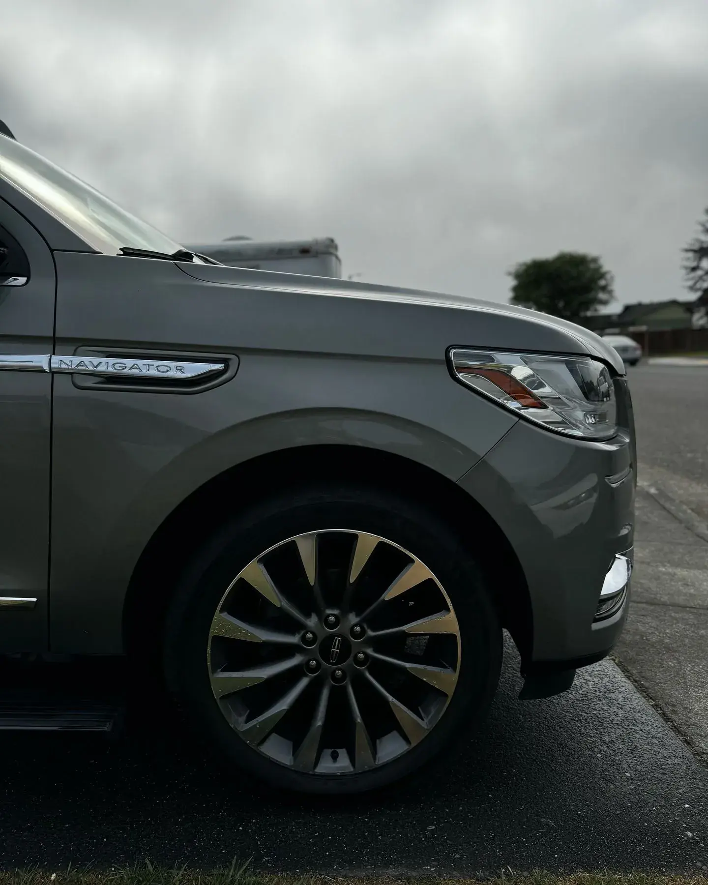 Side view of a Lincoln Navigator, highlighting its polished exterior and sleek wheel design.